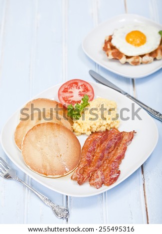 American style breakfast of pancakes, bacon and eggs