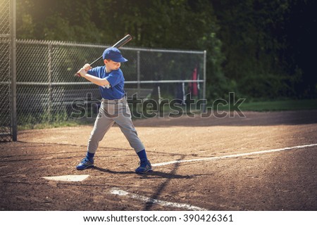 Boy waiting for the ball in a baseball game