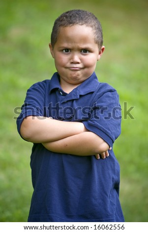 stock-photo-young-angry-boy-outside-with-folded-arms-16062556.jpg