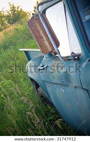 Abandoned rusty old truck in a field