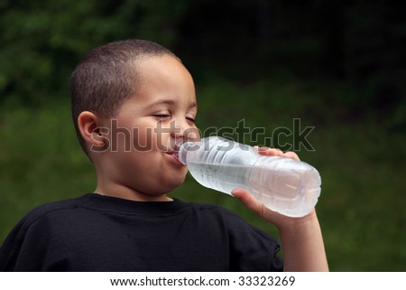 Latino boy drinking water from bottle