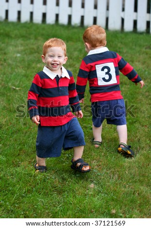 Twin baby boys playing outside