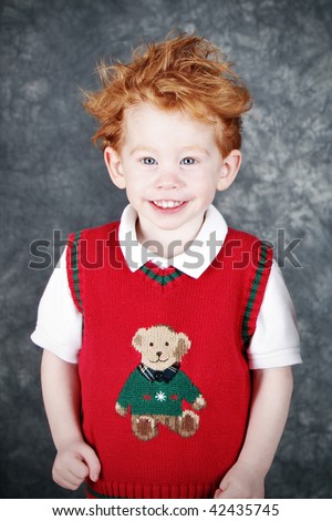 stock photo Cute redhead boy in sweater vest Christmas portrait