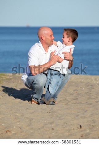 Father and son hugging at the beach