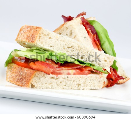 Bacon, lettuce and tomato sandwich on a white plate