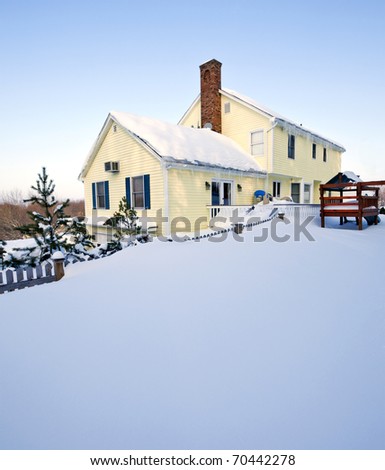 Typical colonial style house in deep snow and ice