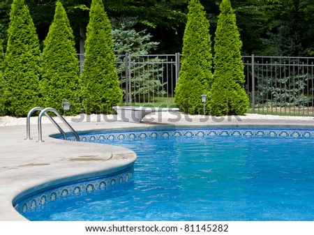 Generic small fenced swimming pool with diving board