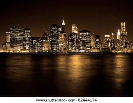 Lower Manhattan in New York City at night with reflection in water