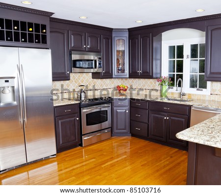 Modern domestic kitchen with new appliances and wooden floor