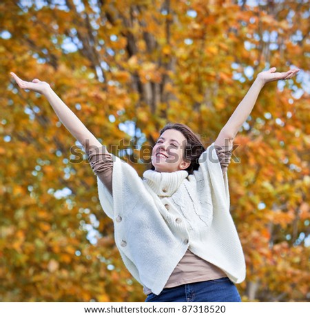 Pretty girl waving arms in air during fall
