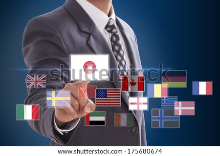 Businessman pushing on a touch screen interface, choosing Japan Flag
