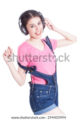 Young woman listening to music and dancing on white background