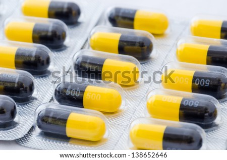 Black and yellow capsule pack medicine heath concept