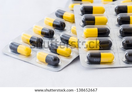Black and yellow capsule pack medicine heath concept