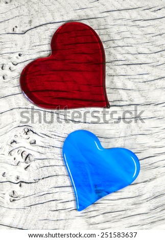 A couple in love - Red and Blue glass Heart Symbols.