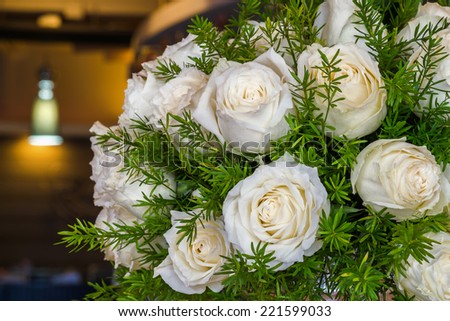 White Rose with Asparagus fern in a glass vase