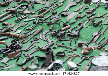 Collection of old tools of the wrench, hammer, scissors for metal and pipe wrench on green background
