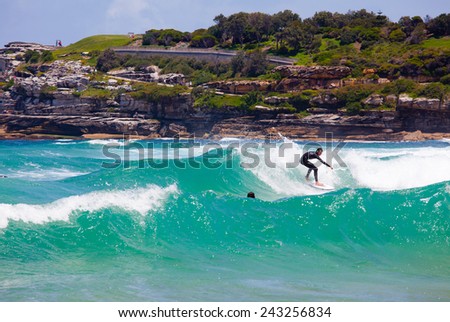 SYDNEY, AUSTRALIA - DEC 10: An unidentified surfer tackles sudden high waves of the Tasman Sea on Bondi Beach in Sydney, Australia on December 10, 2011