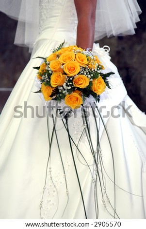 wedding bouquet from yellow roses in hand of the bride