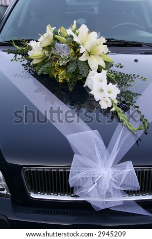this is a wedding car decoration. flower bouquet on a wedding car.