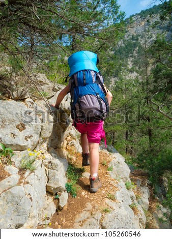 Hiker climbing on a rocky path