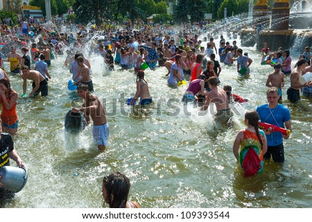 MOSCOW - JULY 14: Young people shooting and throwing water at each other during flash mob 