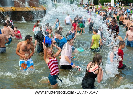 MOSCOW - JULY 14: Young people shooting and throwing water at each other during flash mob 