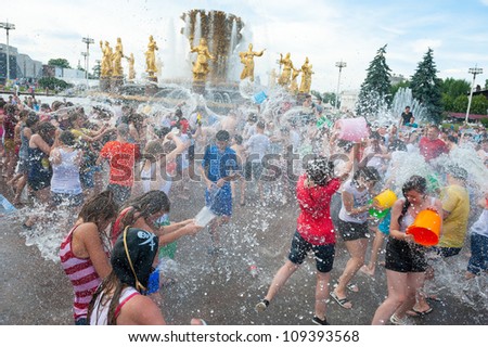 MOSCOW - JULY 14: Young people shooting and throwing water at each other during flash mob \