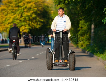 MOSCOW - SEPTEMBER 12: Man rides Segway near Gorky Park on September 12, 2012 in Moscow. City government has built a new bicycle path on the embankment of the Moscow River for citizens recreation.