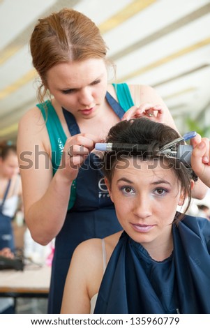 MOSCOW - APRIL 19: Unidentified orphan children, age 13-16, compete in hairdressing at the contest Young Master on April 19, 2013 in Moscow. Orphans were trained by charitable foundation Color of Life