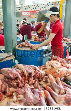 MOSCOW - MAY 18: Unidentified butcher working in the Dorogomilovsky agricultural market on May 18, 2013 in Moscow. It is the oldest and most popular food market in the center of Moscow.