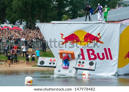 MOSCOW - JULY 28: Competitors perform a flight on Red Bull Flugtag on July 28, 2013 in Moscow. Red Bull Flugtag is an event in which competitors attempt to fly homemade human-powered flying machines