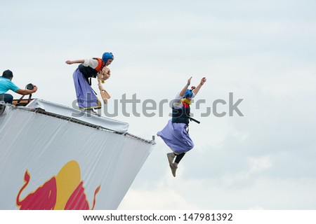 MOSCOW - JULY 28: Competitors jump to water on Red Bull Flugtag on July 28, 2013 in Moscow. Red Bull Flugtag is an event in which competitors attempt to fly homemade human-powered flying machines