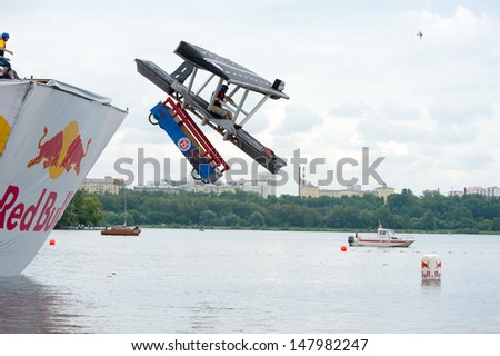 MOSCOW - JULY 28: Competitors perform a flight on Red Bull Flugtag on July 28, 2013 in Moscow. Red Bull Flugtag is an event in which competitors attempt to fly homemade human-powered flying machines