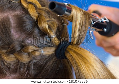 Stylist make curls hair in hair style salon