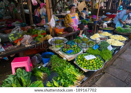 MAEKLONG, THAILAND - MARCH 24: Vendor sells fresh local agricultural production on March 24, 2014 in famous Maeklong Railway Market also known as Talad Rom Hub or Umbrella Pulldown Market
