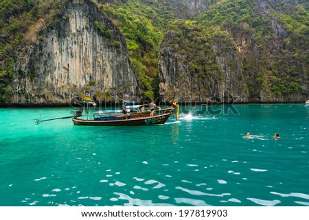 PHI PHI ISLANDS, THAILAND - APRIL 4: Unidentified people visit and swim in lagoon with turquoise water on April 4, 2014 in Phi Phi Islands, Thailand.