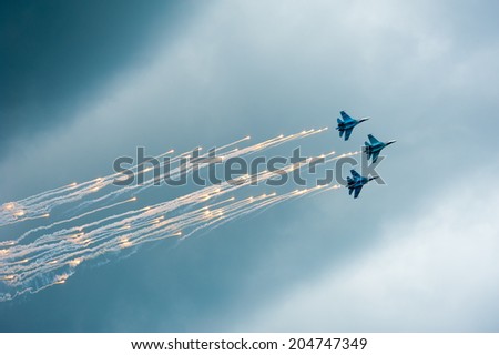 BIG ZAVIDOVO, RUSSIA - JULY 5: Group of russian military jets Su 27 performs at open-air rock festival \