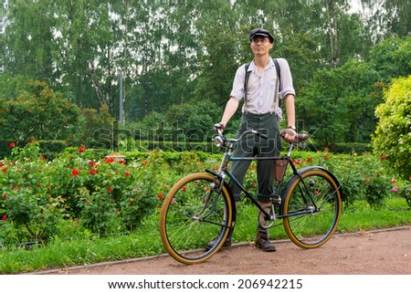 MOSCOW - JUNE 7: Member of the Historic Bike Ride in the park Sokolniki on June 7, 2014 in Moscow. At this event participants in period costumes ride vintage and military bikes 19-20th centuries