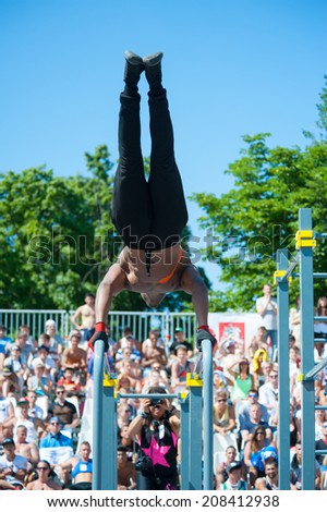 MOSCOW - JULY 26: Unidentified athlete performs during the street workout championship at Moscow City Games in Luzhniki on July 26, 2014 in Moscow.