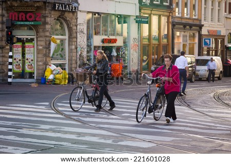 AMSTERDAM - AUGUST 29: Unidentified people go to work in the morning on August 29, 2014 in Amsterdam.