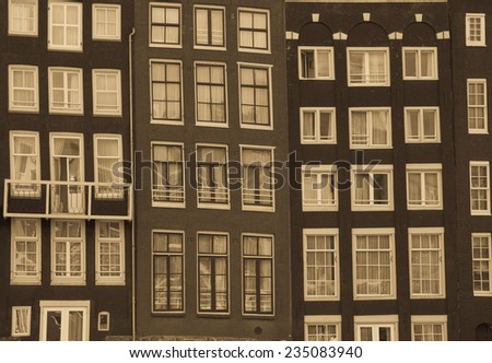 Facades of houses in old city in Amsterdam. Retro colors