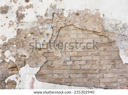 Fallen plaster on brick wall background