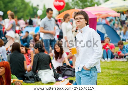 MOSCOW - JUNE 20, 2015: Young woman drinks beer on XII International Jazz Festival 
