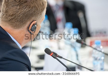 Speaker at business conference and presentation. Focus to microphone. No recognizable faces