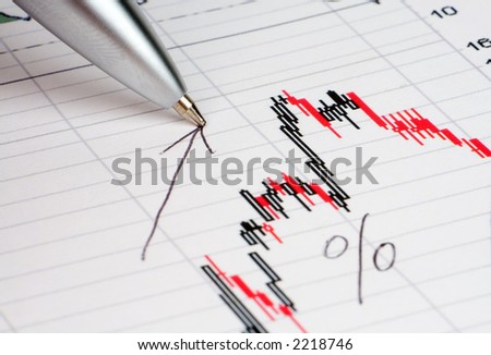 Pen showing diagram on financial report/magazine
