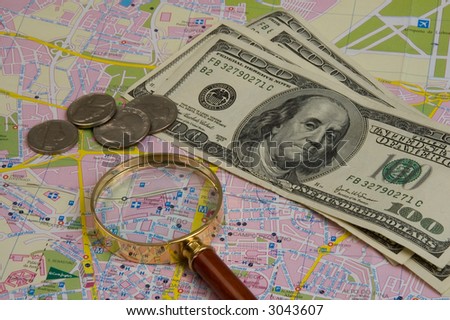 Objects for planning travel - a map, a magnifier, money