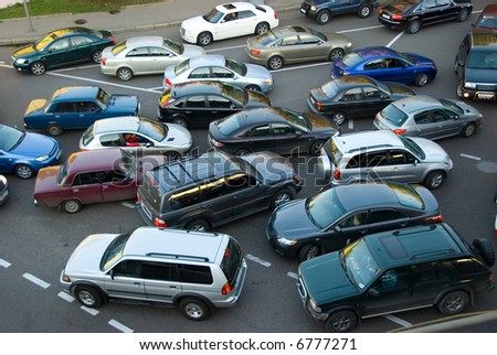 Traffic jam on the road, a lot of cars which go towards each other and to the different directions