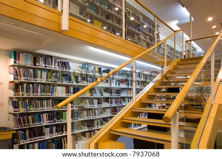 Modern library interior, a lot of books on the bookshelves