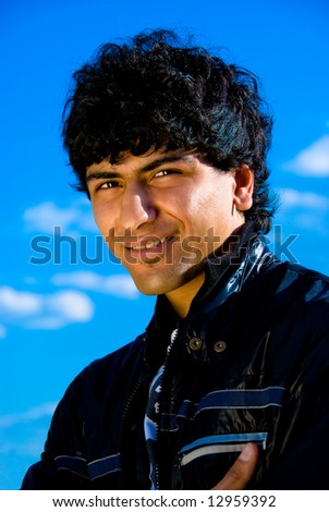 Arabian guy portrait over blue sky background